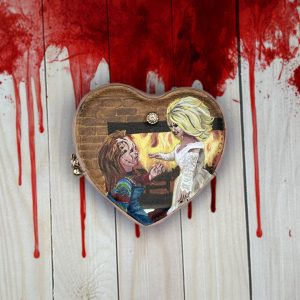 Chucky proposing to Tiffany on a heart shaped coin purse.